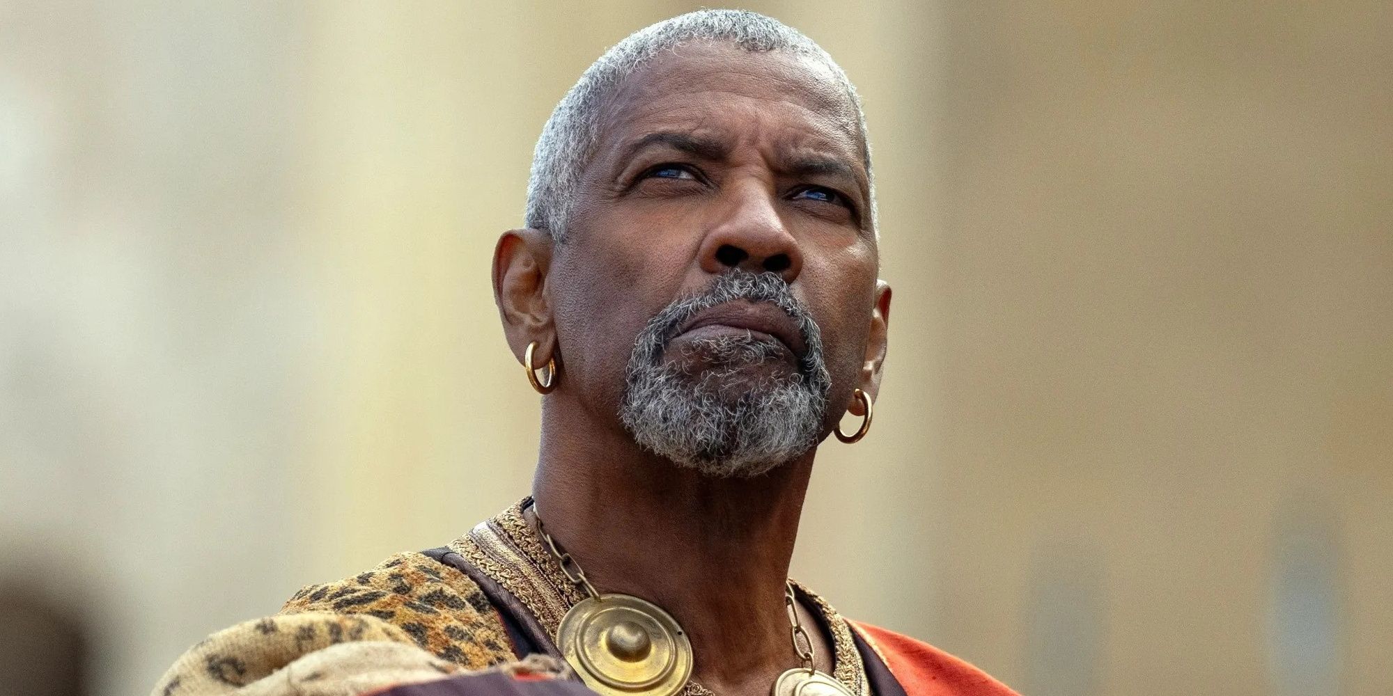 Denzel Washington as Macrinus looking up in Gladiator II