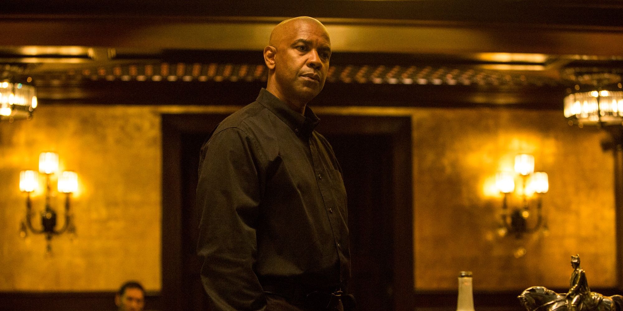 Denzel Washington wearing black and looking intense in The Equalizer